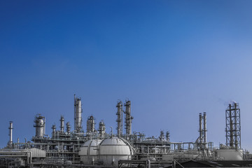 Fototapeta na wymiar Manufacturing of petrochemical plant on blue sky background, Oil and gas refinery plant with storage sphere tank