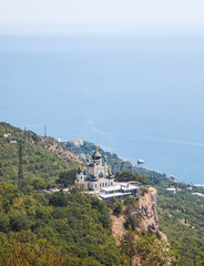 Fototapeta na wymiar Church of Holy Resurrection of Christ on Red cliff and township Foros on Black sea coast, Crimea, Russia