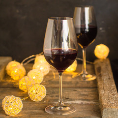 wine - red wine in a transparent glass on a wooden table. Top view. copy space