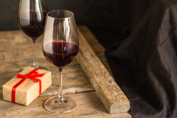 wine - red wine in a transparent glass on a wooden table. Top view. copy space
