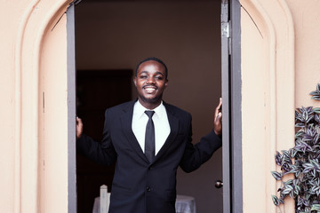 African business man smile and open the door