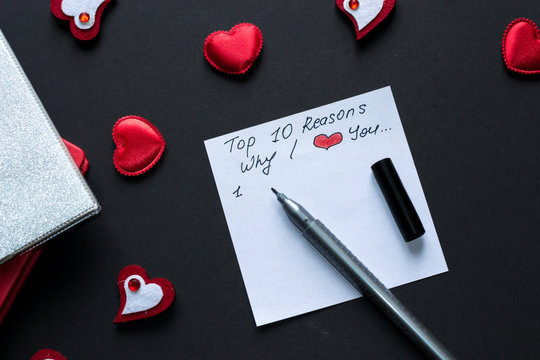 Top 10 Reasons Why I Love You. Valentine's Day Background With Red Hearts. White Paper And Pen On Black.