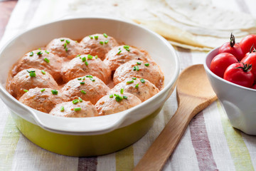 Chacken meatballs baked in creamy tomato sauce