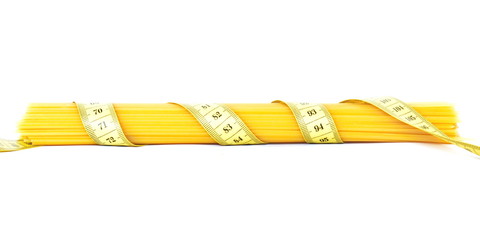Bunch of wheat raw spaghetti wrapped yellow measuring tape on white background. Side view