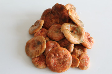 A bunch a saffron milk cap mushrooms (Lactarius deliciosus), similar to Lactarius Sanguifluus and Lactarius Deterrimus, on a white table