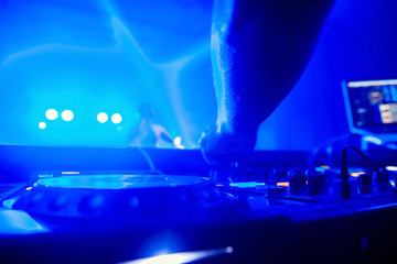 Dj playing the track in the nightclub at party closeup