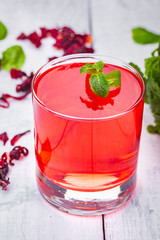 Jelly with hibiscus in portion glass on wooden background. Close up