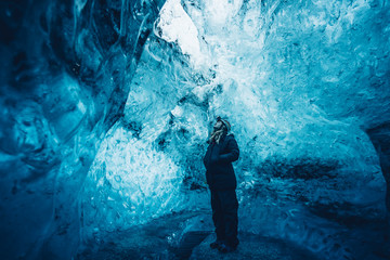 Man in beautiful blue ice cave