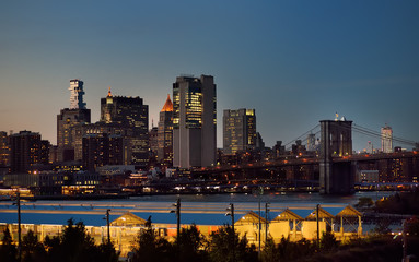 Amazing New York City Manhattan skyline panorama view over Hudson River at dusk. Brooklyn bridge.