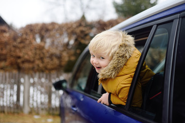 Cute little boy ready for a roadtrip or travel. Family car travel with kids