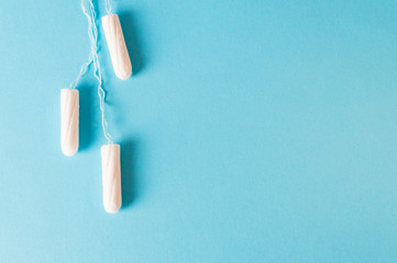 Women protection - tampons on the blue background.