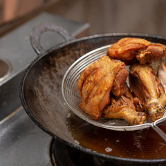 Fried chicken in hot oil and boiling in pan