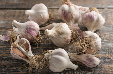 Natural pattern with fresh organic vegan garlic on a wooden background. copy space.