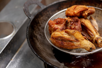 Fried chicken in hot oil and boiling in pan