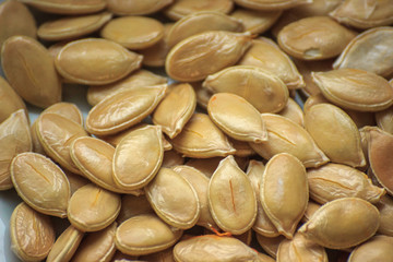 a lot of dry pumpkin seeds. abstraction for background. healthy food. vegan, raw
