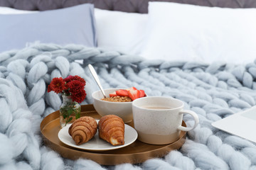 Tray with breakfast on bed. Interior element