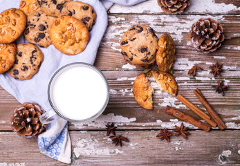 Christmas background with treats for Santa homemade baked cookies, cup of milk on a wooden table. Top view
