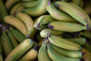 Bananas stacked together at market