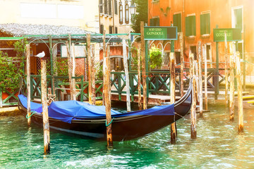 Fototapeta na wymiar Canal with gondola in Venice with gondola service sign. Tourism concept in Europe