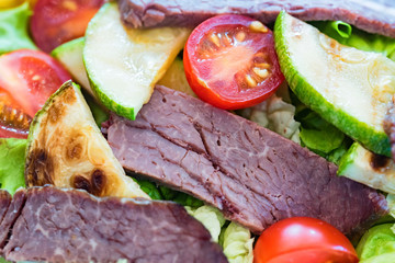 Close up fresh salad with beef, aubergines and tomatoes