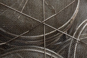 Obraz premium Used steel wire mesh filter. Centre in sharp focus and surface curves away from view.