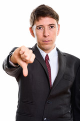 Studio shot of businessman giving thumb down 