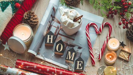 Christmas decor: Warm sweater, cup of hot cocoa with marshmallow, candy, candles, Christmas tree. Winter mood, Cozy Home