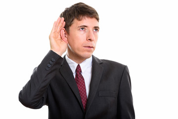 Studio shot of thoughtful businessman listening against white background
