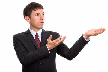 Studio shot of businessman showing or holding something