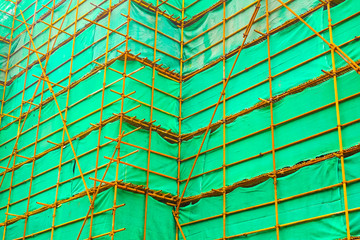Steel scaffolding with a green curtain