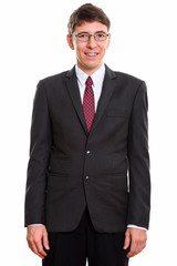 Studio shot of happy businessman smiling and wearing suit