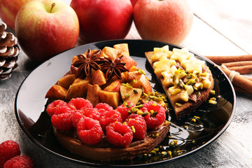Peanut butter sandwiches with apple and banana and raspberries for breakfast