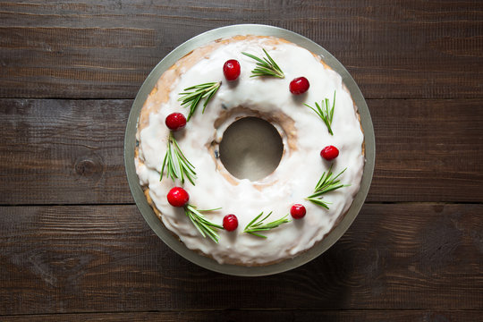 Homemade Christmas Cake With Garnish Cranberry And Rosemary On Decorative Plate. Top View.