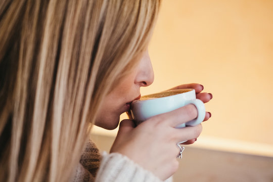 Young Woman Drinking From Cup