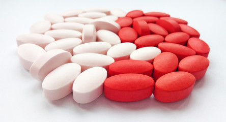 Assorted colorful pharmaceutical medicine pills, tablets and capsules on white background. Pharmacy theme, health care, drug prescription for treatment medication and pharmaceutical medicament