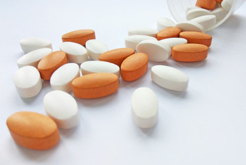 Assorted colorful pharmaceutical medicine pills, tablets and capsules on white background. Pharmacy theme, health care, drug prescription for treatment medication and pharmaceutical medicament