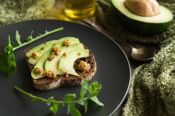 Rye bread with avocado and mustard seeds