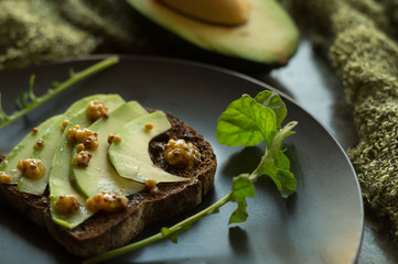 Rye bread with avocado and mustard seeds
