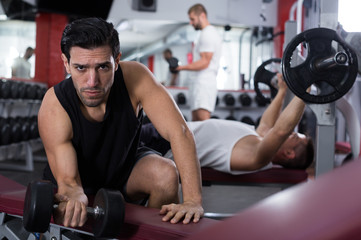 Man with dumbbells at gym