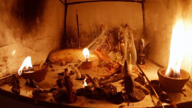 icon-lamps burn sticks smoke little murti of Ganesha and Laxmi banana