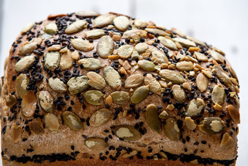 Healthy gluten free bread with seeds and nuts on wooden background