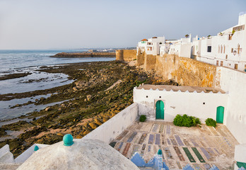 Whitewashed waterfront buildings in Asilah, Morocco. © Anette Andersen