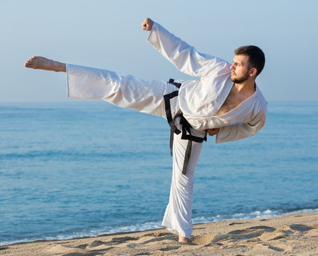 young man practicing karate positions