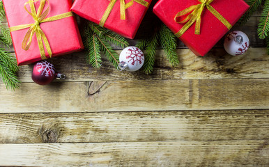 Christmas background with decorations and gift boxes on wooden background. Top view