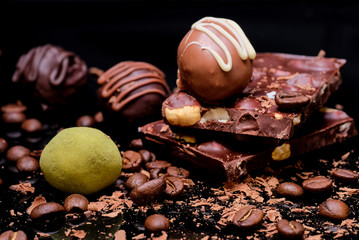 Chocolate truffles, slices of chocolate with hazelnats, and coffee beans