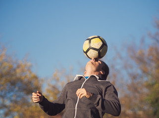 Soccer Player Balancing Football