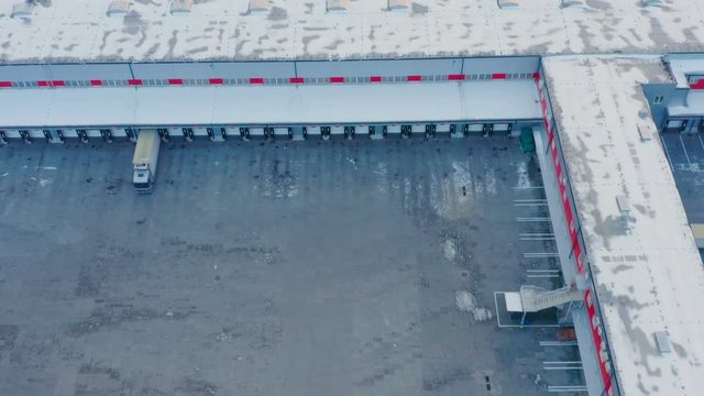 Aerial look-up view of the big warehouse logistics center in winter day