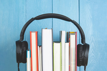 headphone and books on blue background