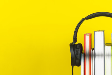 headphone and books on yellow background