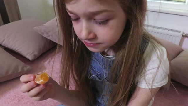 Girl eats mandarins